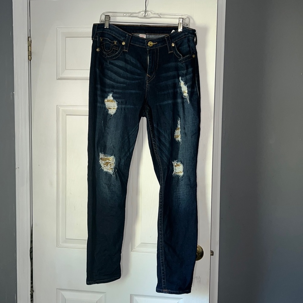 Dark denim with distressing. Gold sequins inside distressing.